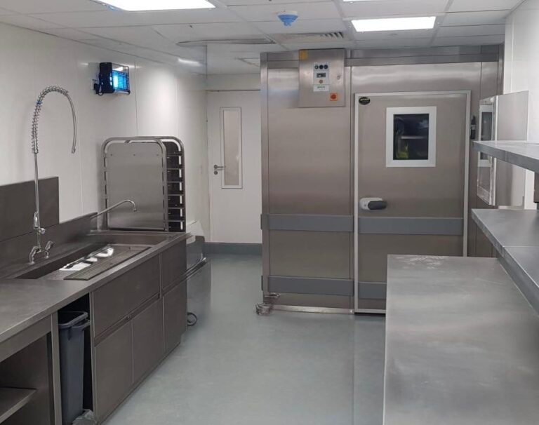 Commercial kitchen with stainless steel refrigeration units.